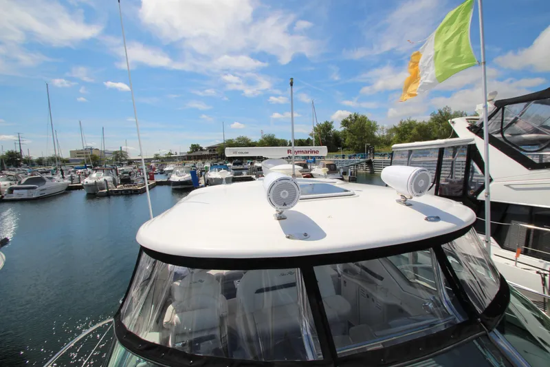 Slide: The Image of 2008 Sea Ray 44 Sundancer yacht docked at marina under blue sky. - 58