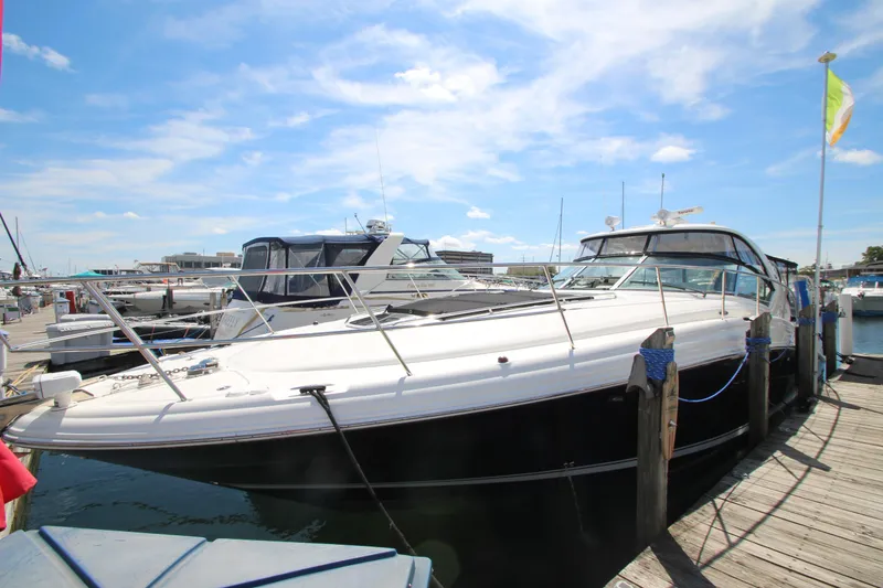 Slide: The Image of 2008 Sea Ray 44 Sundancer yacht docked at marina under blue sky. - 6