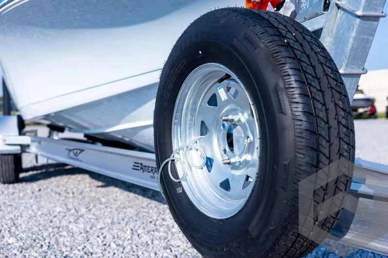 Slide: The Image of 2026 Tidewater 2110 Bay Max boat trailer tire on gravel surface. - 10