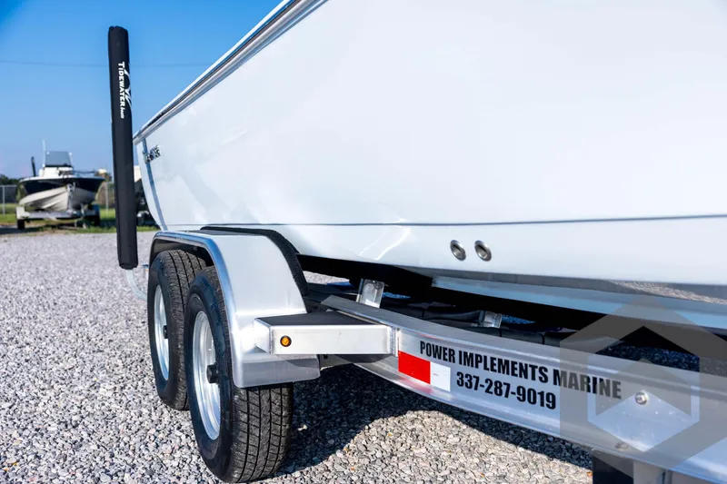 Slide: The Image of 2026 Tidewater 2110 Bay Max boat on trailer, gravel lot background. - 13