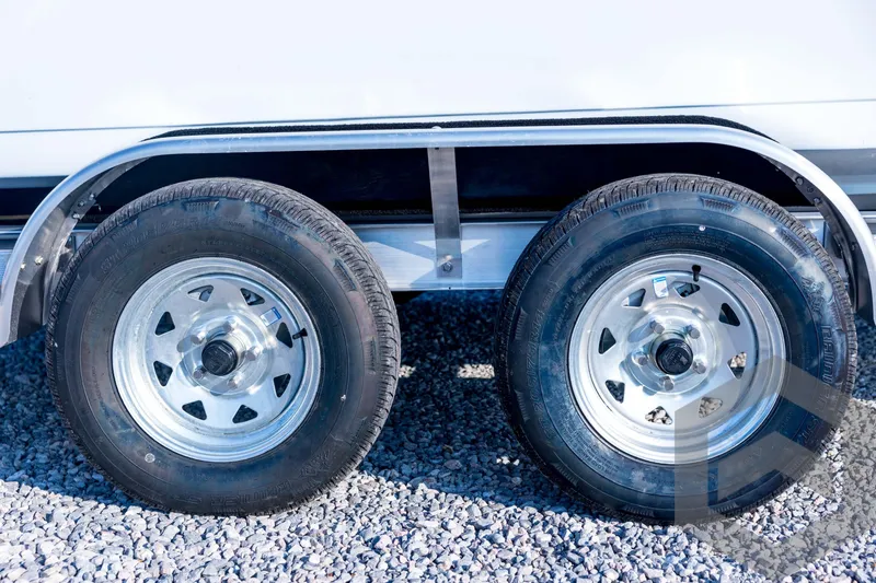 Slide: The Image of Trailer wheels of a 2026 Tidewater 2110 Bay Max on gravel surface. - 14