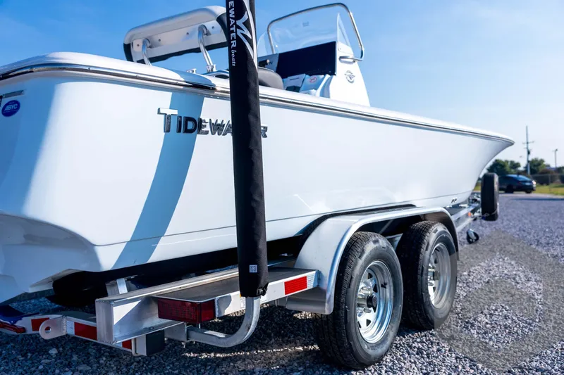 Slide: The Image of 2026 Tidewater 2110 Bay Max boat on trailer, parked on gravel under clear sky. - 16