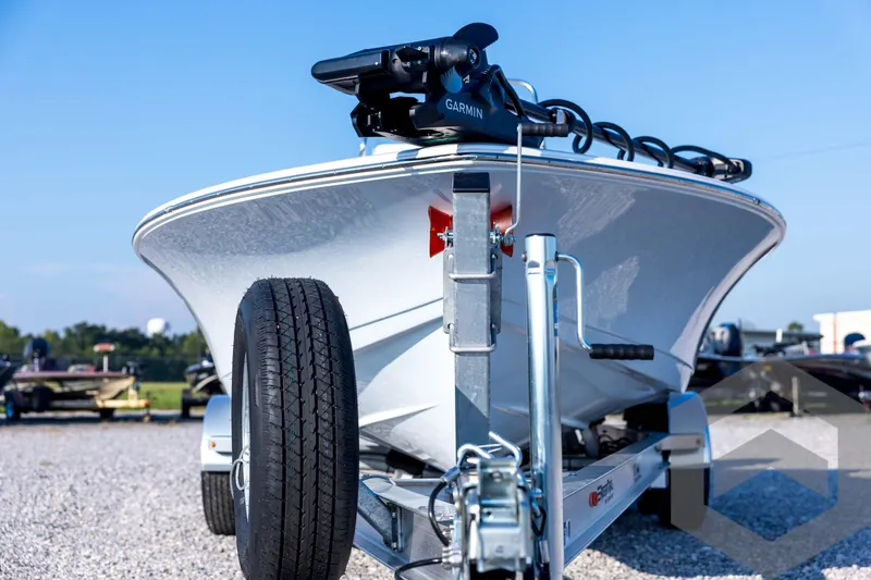 Slide: The Image of 2026 Tidewater 2110 Bay Max boat on trailer, featuring Garmin equipment, parked on gravel. - 2
