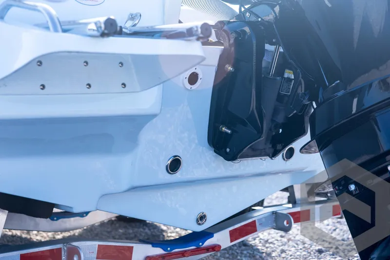 Slide: The Image of 2026 Tidewater 2110 Bay Max boat's rear view with motor and trailer details. - 24