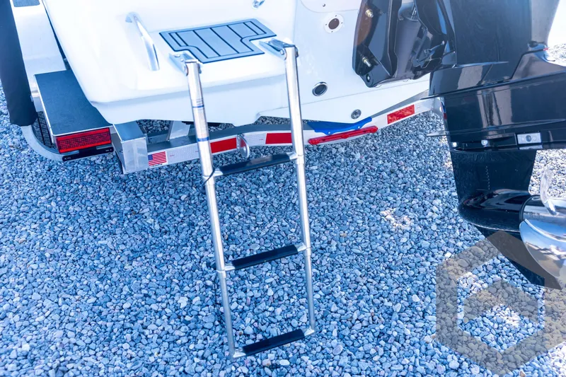 Slide: The Image of 2026 Tidewater 2110 Bay Max boat with ladder and motor on gravel surface. - 26