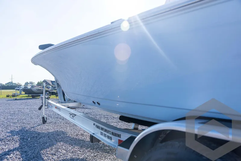 Slide: The Image of 2026 Tidewater 2110 Bay Max boat on trailer, sunlit outdoor setting. - 29