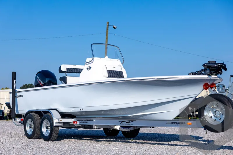 Slide: The Image of 2026 Tidewater 2110 Bay Max boat on trailer, displayed outdoors under clear blue sky. - 3