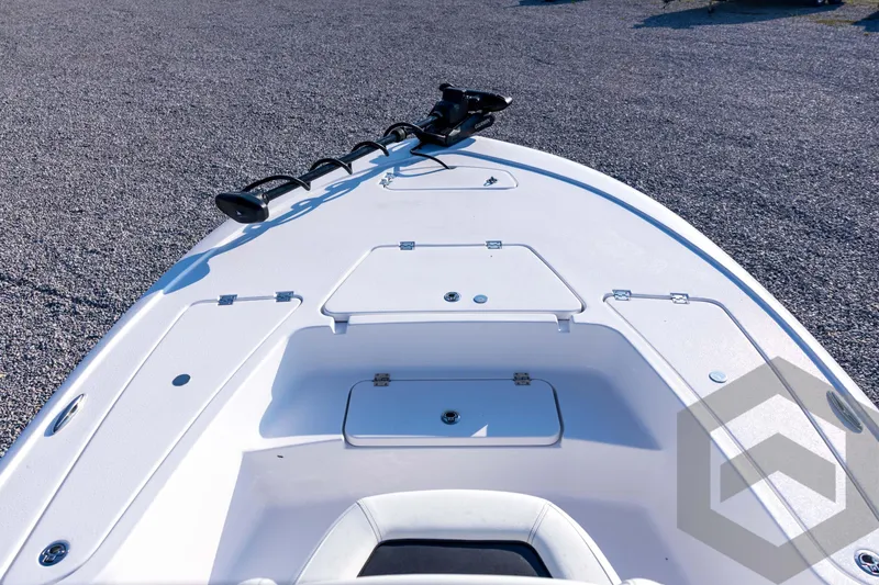 Slide: The Image of 2026 Tidewater 2110 Bay Max boat deck with storage compartments and trolling motor. - 33