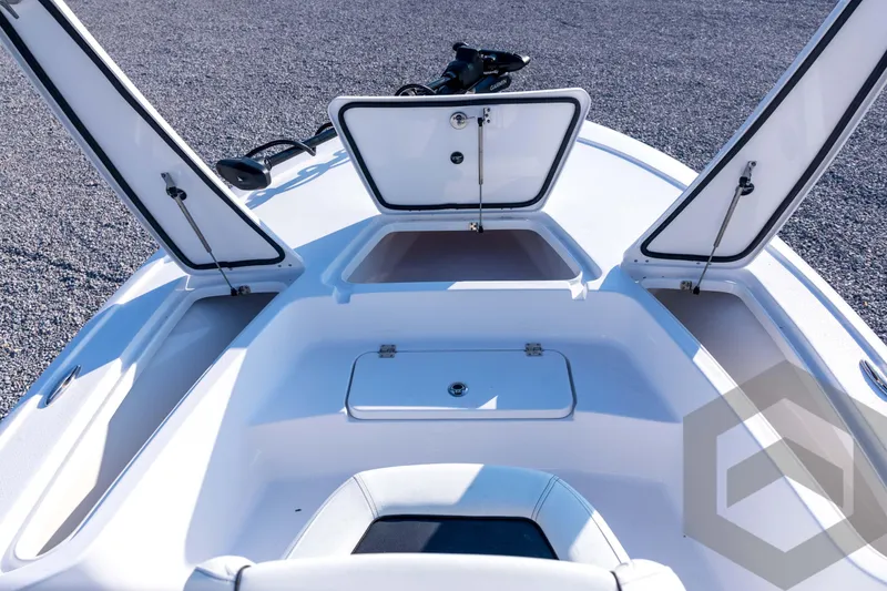 Slide: The Image of 2026 Tidewater 2110 Bay Max boat with open storage compartments on deck. - 39