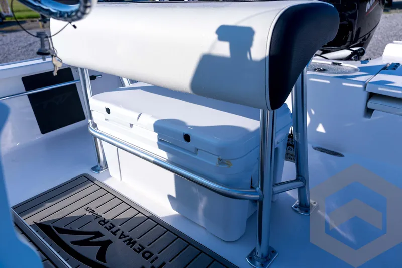 Slide: The Image of 2026 Tidewater 2110 Bay Max boat interior with cushioned seating and storage. - 58