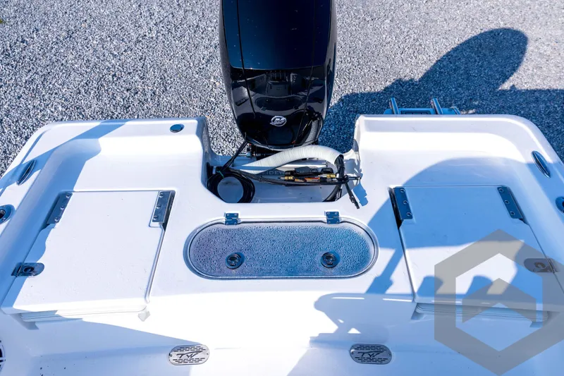 Slide: The Image of 2026 Tidewater 2110 Bay Max boat deck with motor and storage compartments. - 63