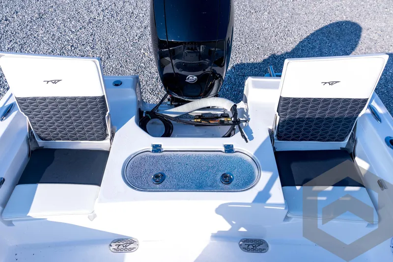 Slide: The Image of 2026 Tidewater 2110 Bay Max boat interior with seating and motor. - 64