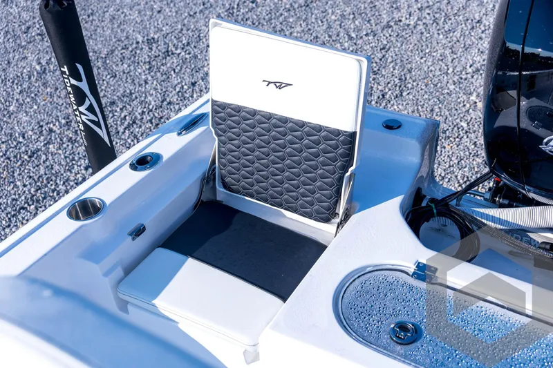 Slide: The Image of 2026 Tidewater 2110 Bay Max boat interior with cushioned seating and storage compartments. - 65