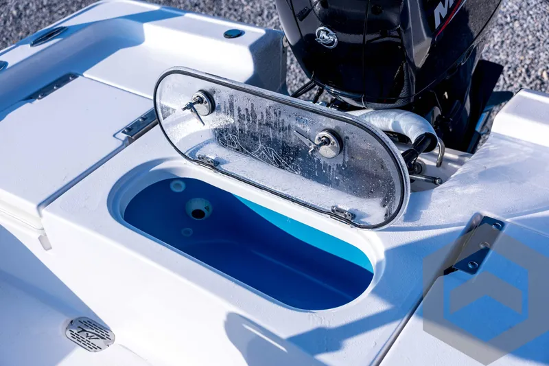 Slide: The Image of 2026 Tidewater 2110 Bay Max boat with open livewell and motor detail. - 67