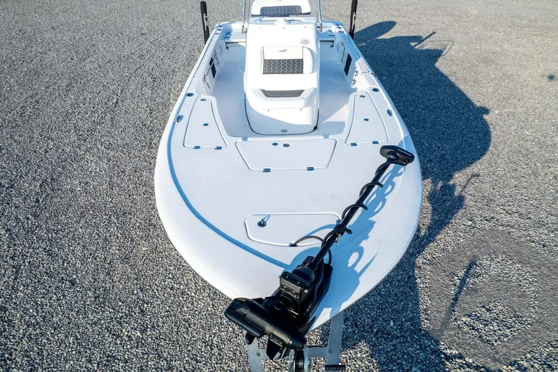 Slide: The Image of 2026 Tidewater 2110 Bay Max boat on gravel, showcasing deck and trolling motor. - 89