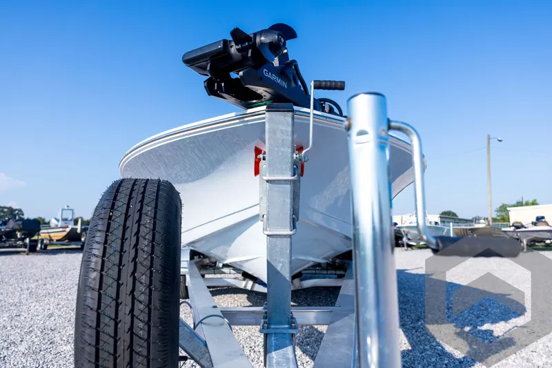 Slide: The Image of 2026 Tidewater 2110 Bay Max boat on trailer, close-up view, clear blue sky. - 9