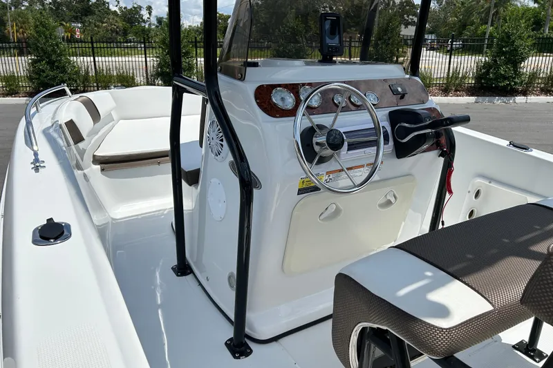 Slide: The Image of 2020 Key Largo 1800 CC boat interior with steering console and seating. - 10