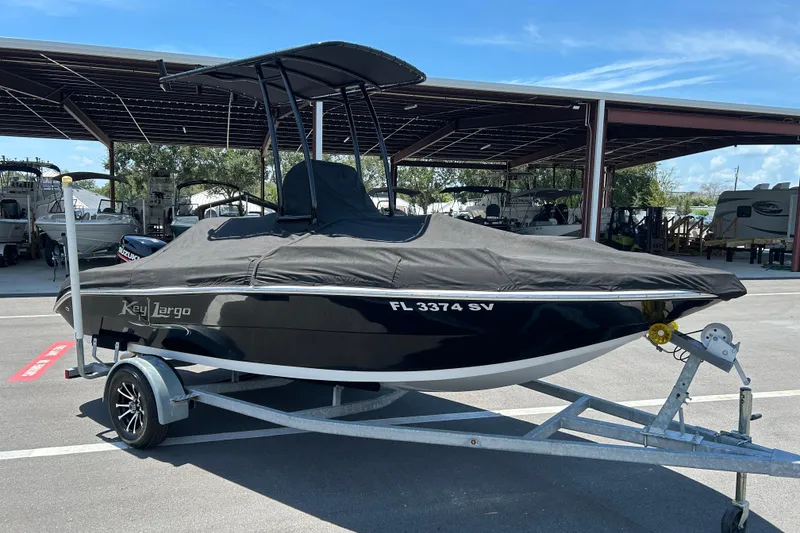 Slide: The Image of 2020 Key Largo 1800 CC boat on trailer, covered and parked outdoors. - 16