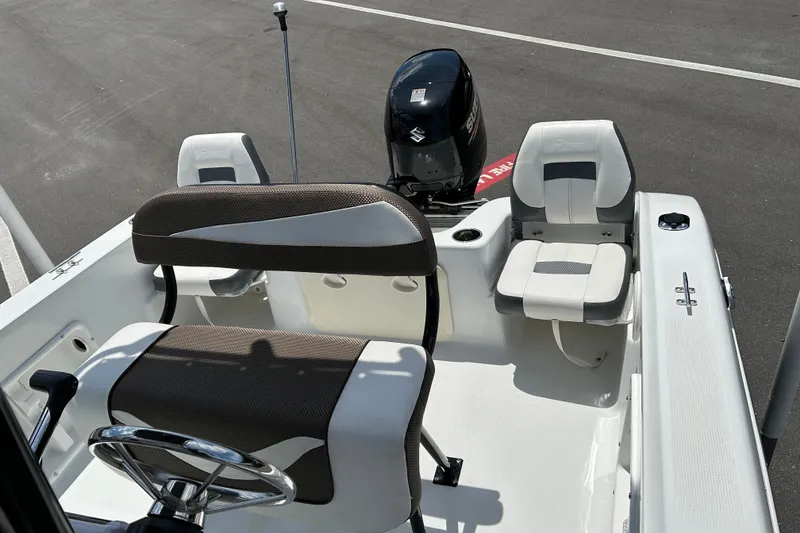 Slide: The Image of 2020 Key Largo 1800 CC boat interior with seating and steering wheel. - 12