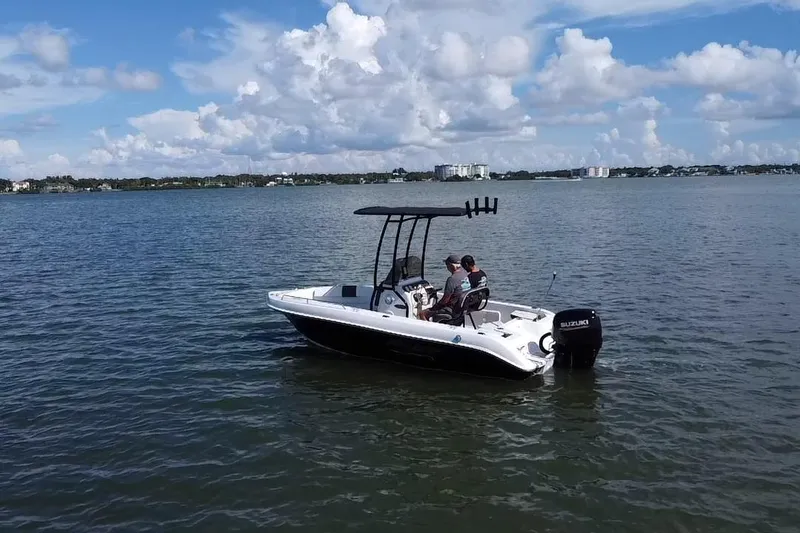 Slide: The Image of 2020 Key Largo 1800 CC boat on calm water under a partly cloudy sky. - 18