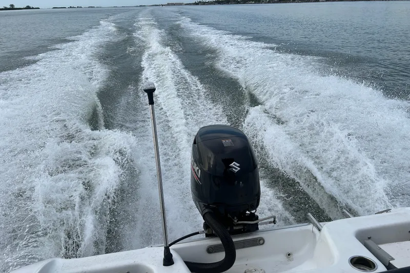 Slide: The Image of 2020 Key Largo 1800 CC boat cruising on water, leaving a wake behind. - 19