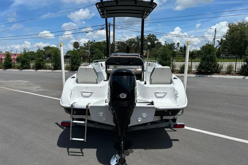Slide: The Image of 2020 Key Largo 1800 CC boat, rear view with outboard motor, parked outdoors. - 3