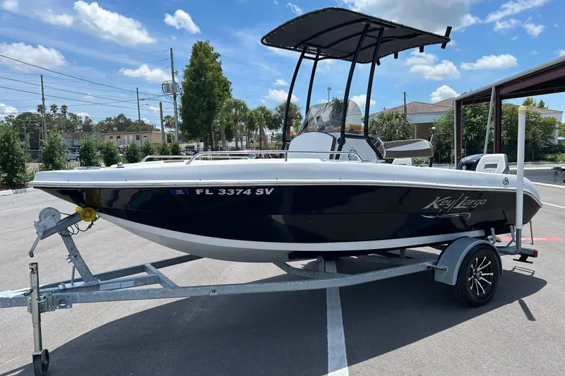 Slide: The Image of 2020 Key Largo 1800 CC boat on trailer, parked outdoors under a clear sky. - 5