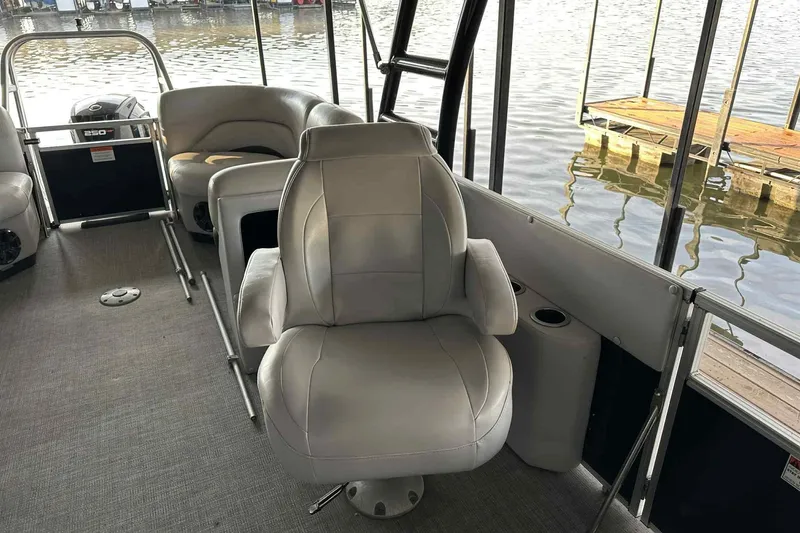 Slide: The Image of 2018 Landau Atlantis 250 Cruise boat interior with plush seating by the water. - 13