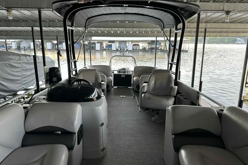 Slide: The Image of Interior of a 2018 Landau Atlantis 250 Cruise pontoon boat docked by the water. - 14