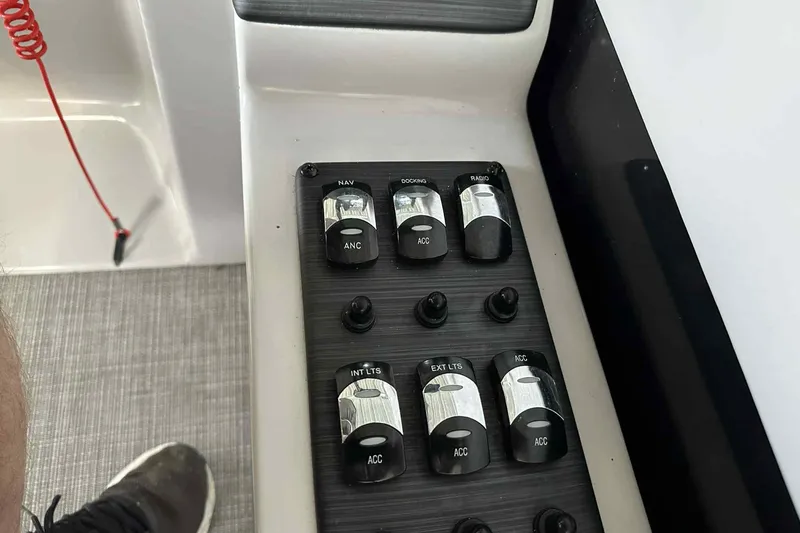 Slide: The Image of Control panel of a 2018 Landau Atlantis 250 Cruise boat with various switches. - 21