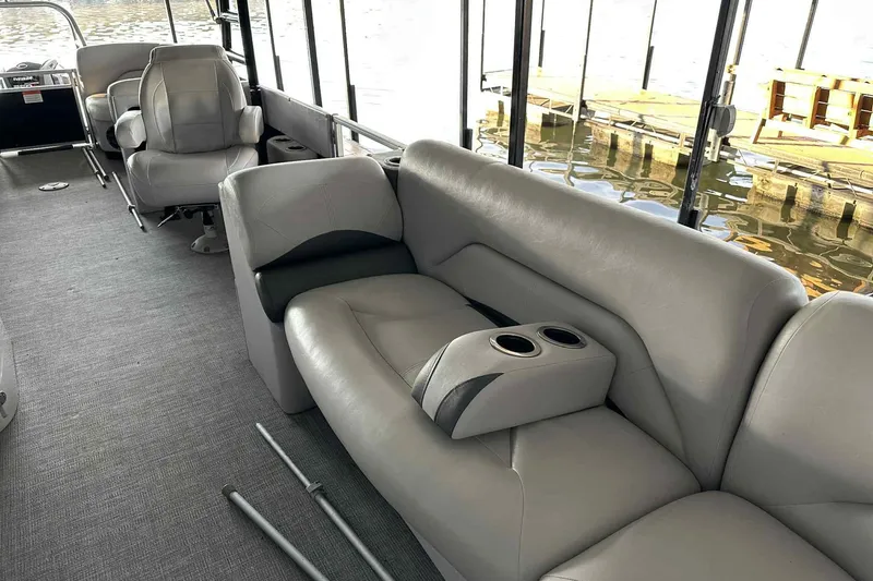 Slide: The Image of Interior of 2018 Landau Atlantis 250 Cruise pontoon boat with gray seating and cup holders. - 23