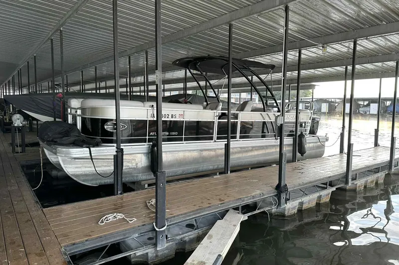 Slide: The Image of 2018 Landau Atlantis 250 Cruise pontoon boat docked in covered marina. - 24