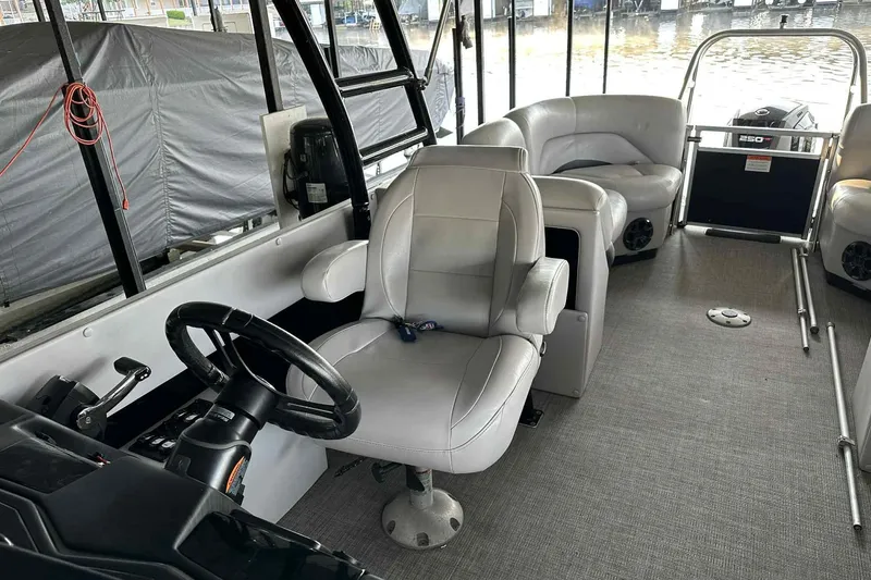 Slide: The Image of 2018 Landau Atlantis 250 Cruise interior with steering wheel and seating. - 28