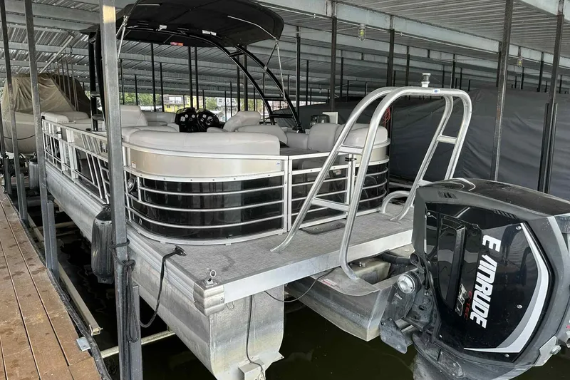 Slide: The Image of 2018 Landau Atlantis 250 Cruise pontoon boat docked with Evinrude outboard motor. - 4