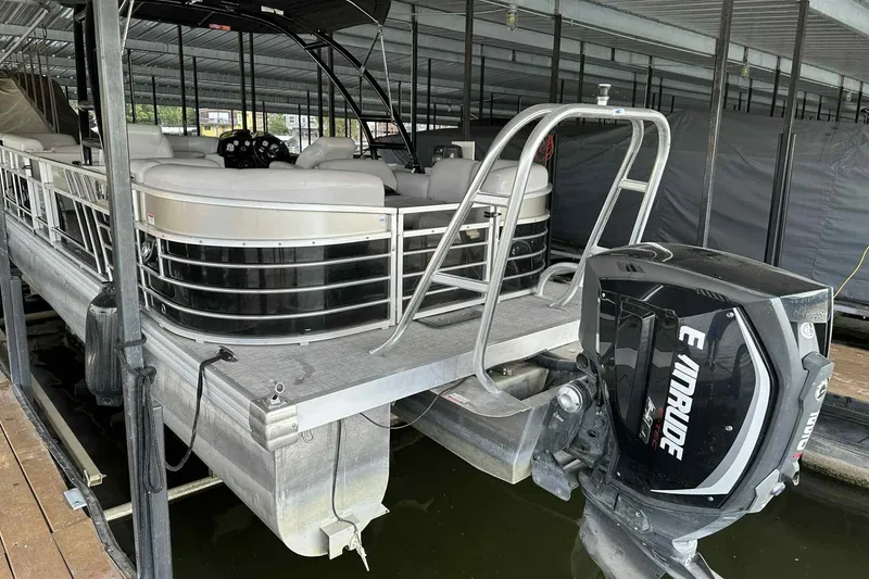 Slide: The Image of 2018 Landau Atlantis 250 Cruise pontoon boat with Evinrude motor in covered dock. - 8
