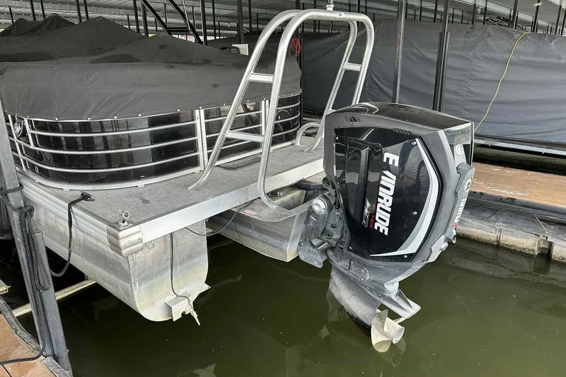 Slide: The Image of 2018 Landau Atlantis 250 Cruise pontoon boat with Evinrude outboard motor in dock. - 9