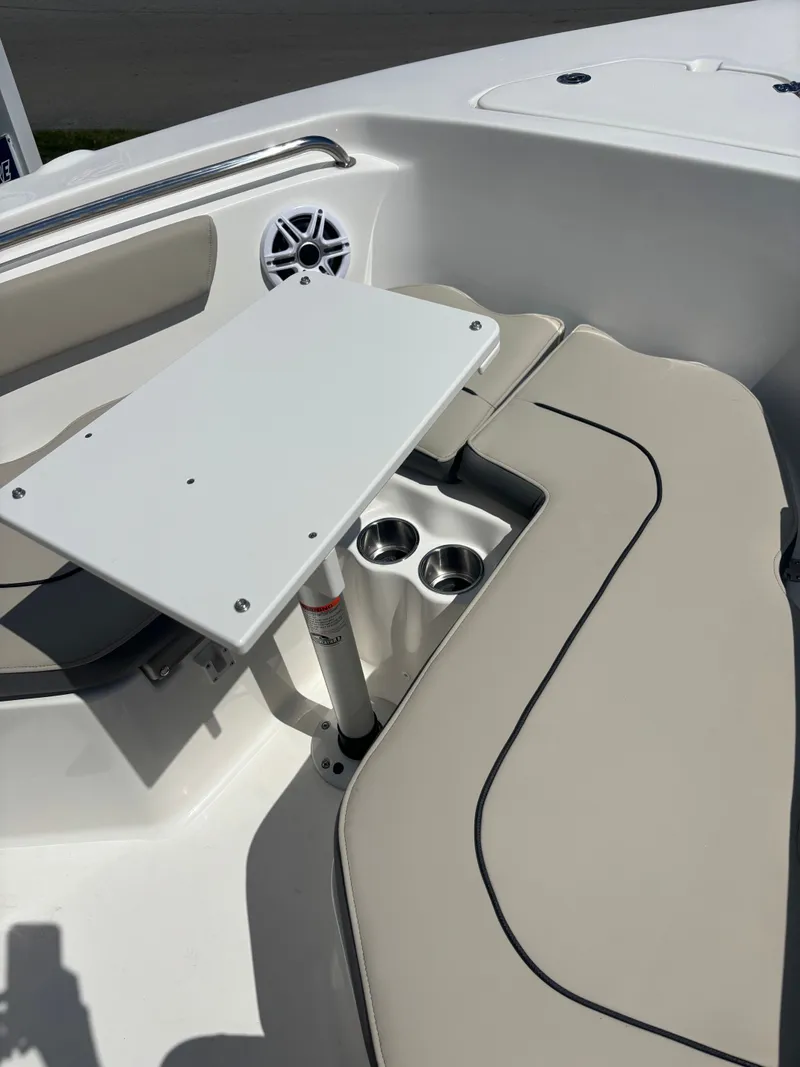 Slide: The Image of 2026 Key West 203 FS boat interior with seating, table, and cup holders. - 15