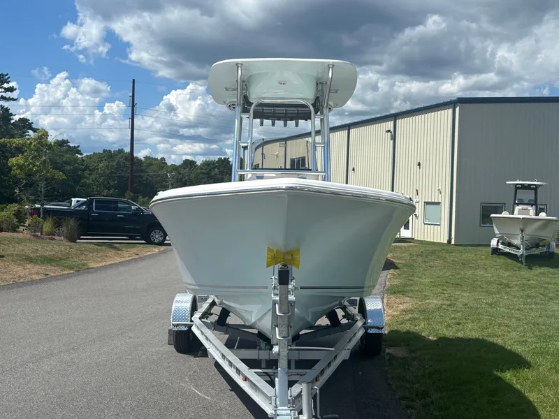 Slide: The Image of 2026 Key West 203 FS boat on trailer, parked outdoors under cloudy sky. - 2