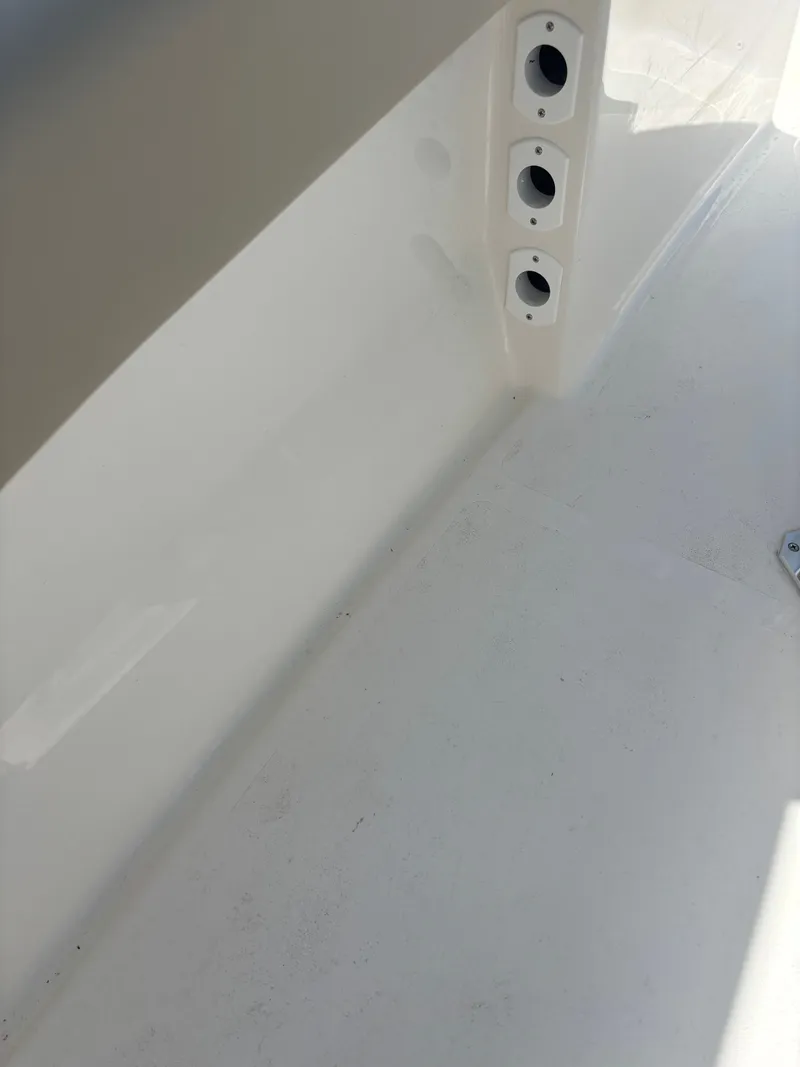 Slide: The Image of Interior view of 2026 Key West 203 FS boat, featuring rod holders and clean white surface. - 23