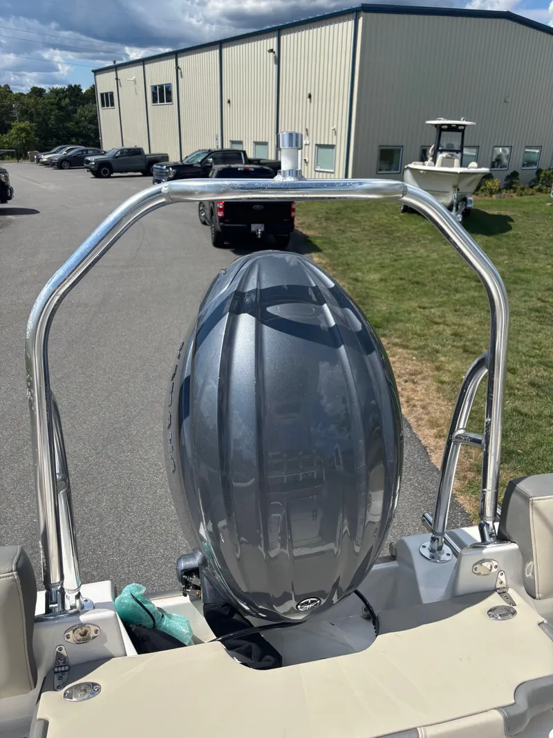 Slide: The Image of 2026 Key West 203 FS boat with a mounted engine, parked outdoors. - 25