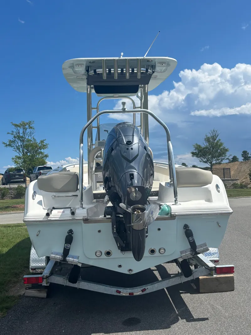 Slide: The Image of 2026 Key West 203 FS boat with outboard motor on trailer, under a clear blue sky. - 3