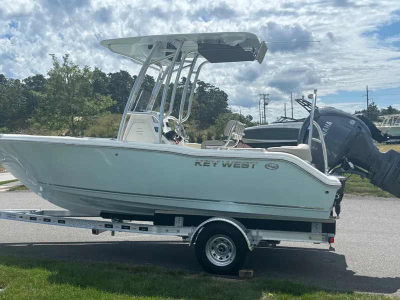 Slide: The Image of 2026 Key West 203 FS boat on trailer, parked outdoors under cloudy sky. - 5