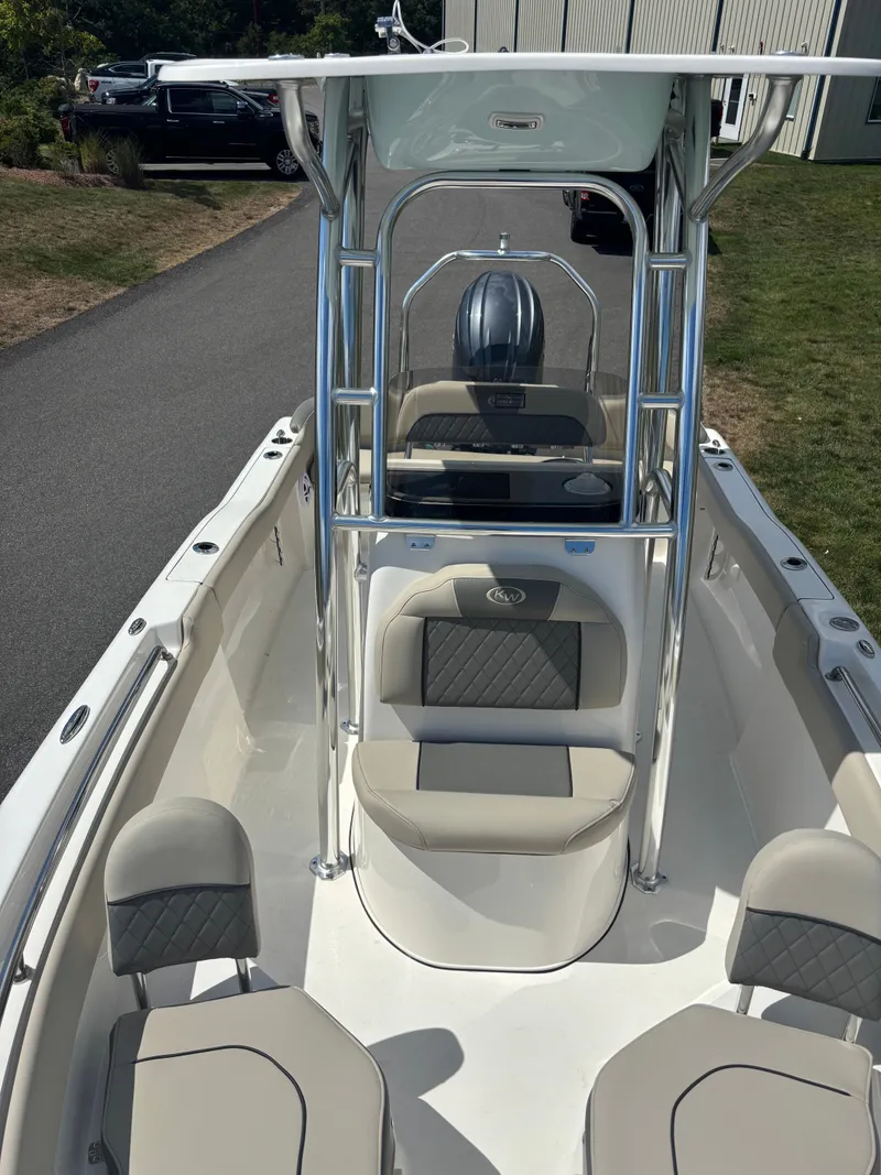 Slide: The Image of 2026 Key West 203 FS boat interior with seating and console, parked outdoors. - 8