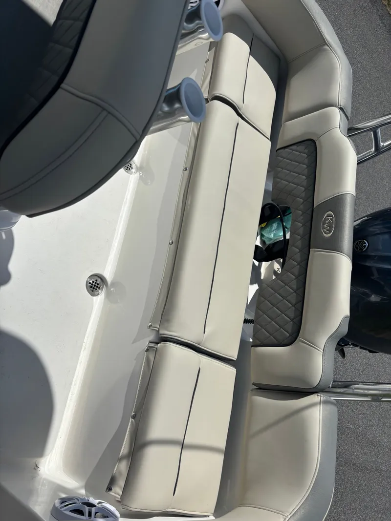 Slide: The Image of 2026 Key West 203 FS boat interior with cushioned seating and cup holders. - 9