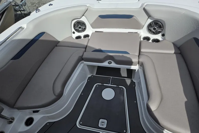 Slide: The Image of 2026 Hurricane Center Console 24 OB boat interior with gray seating and built-in speakers. - 17