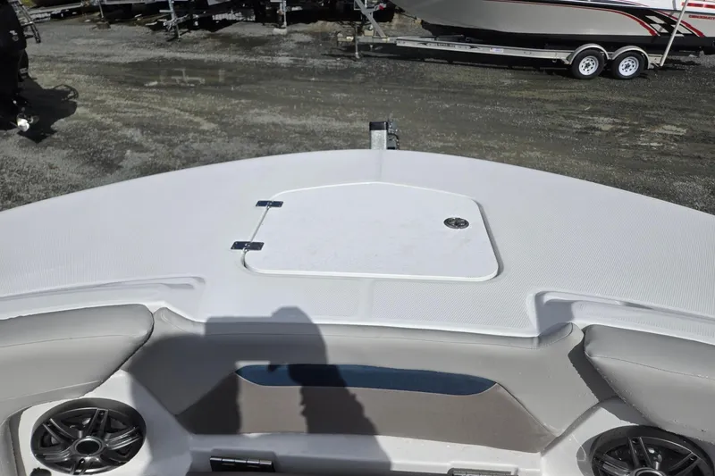 Slide: The Image of 2026 Hurricane Center Console 24 OB boat deck with storage hatch and speakers. - 18