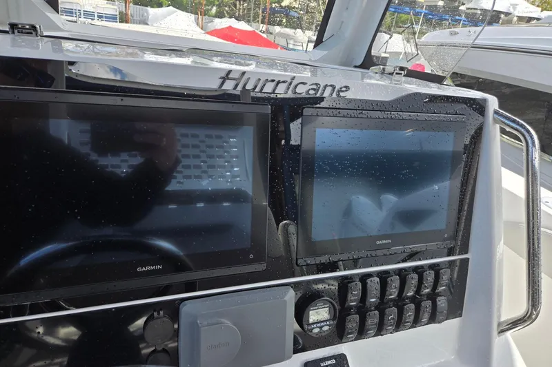 Slide: The Image of 2026 Hurricane Center Console 24 OB dashboard with Garmin displays and controls. - 20