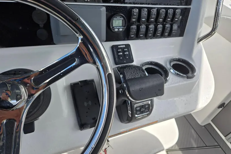 Slide: The Image of Steering console of 2026 Hurricane Center Console 24 OB boat with controls and cup holders. - 21