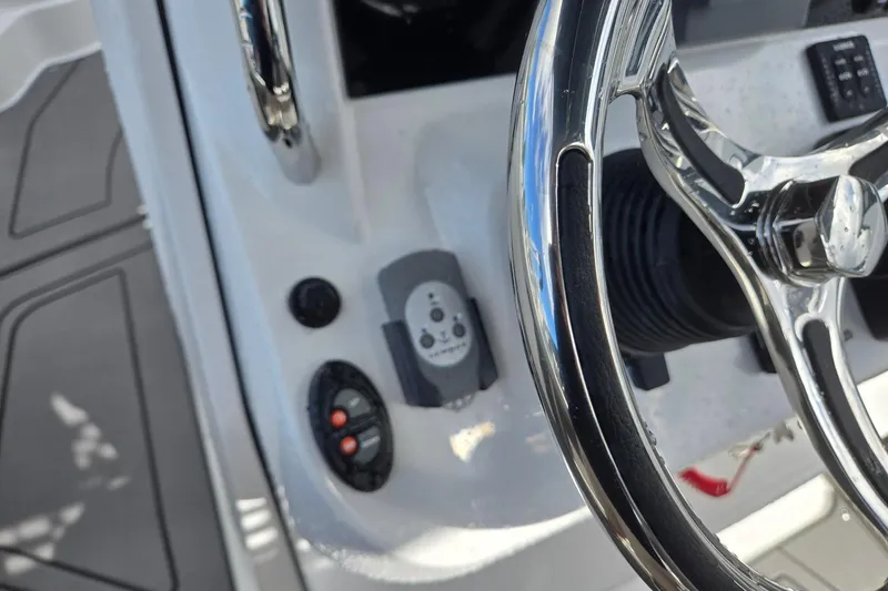 Slide: The Image of Steering wheel and controls of 2026 Hurricane Center Console 24 OB boat. - 22