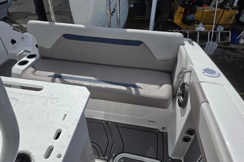 Slide: The Image of 2026 Hurricane Center Console 24 OB boat interior with cushioned seating and cup holders. - 26